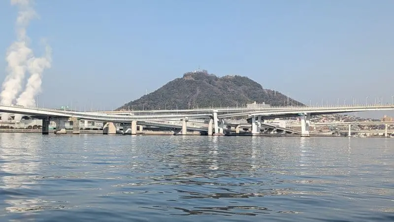 広島湾の海上から望む橋と山の風景